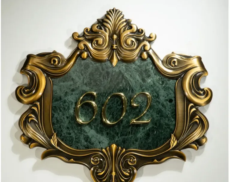 Custom carved hotel room number plaque with raised antique metal border