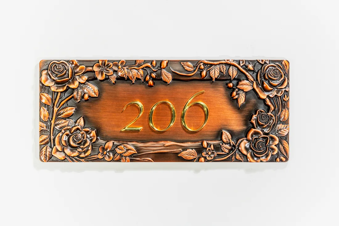 Antique copper address plaque with rose relief border and raised number 206