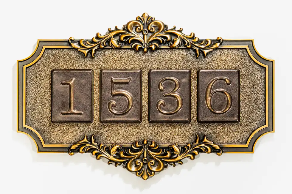 Exterior villa address plaque with ornate raised border and modular numbers