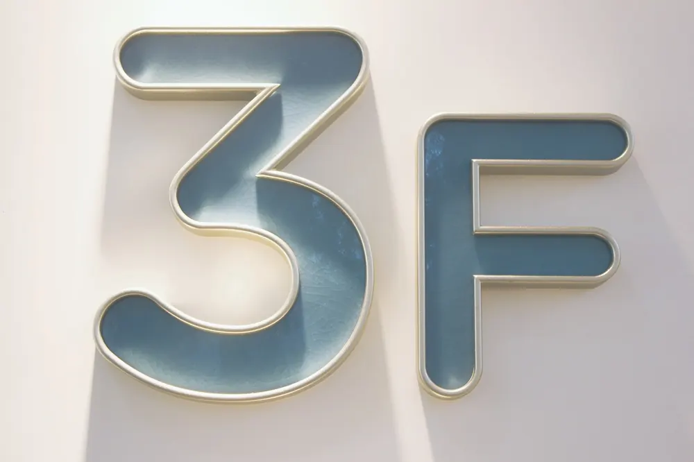 Hotel room number plaque with ceramic inner panel and carved metal border
