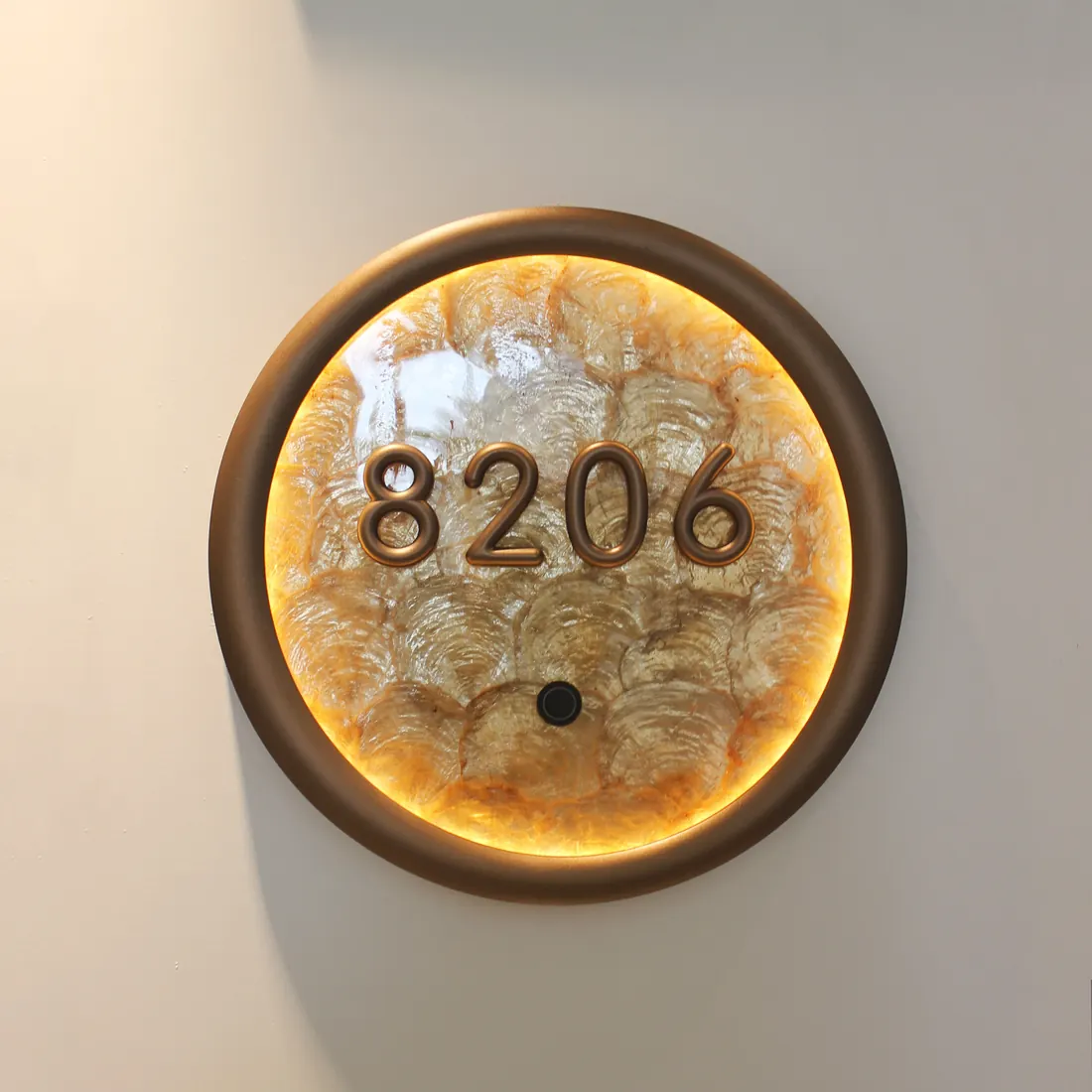 Round backlit hotel room number sign 8206 with warm edge lighting