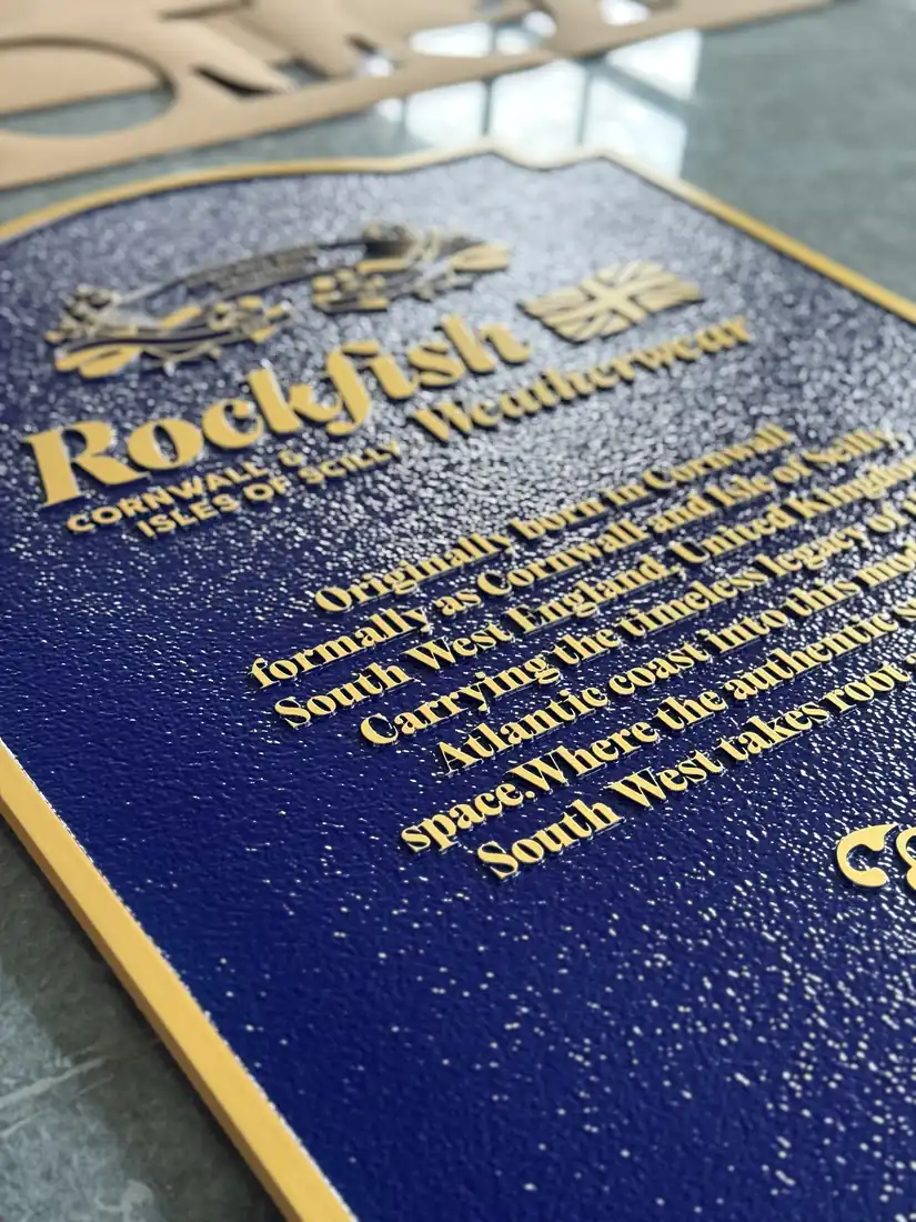 Outdoor color-separated plaque sample with raised text and blue finish