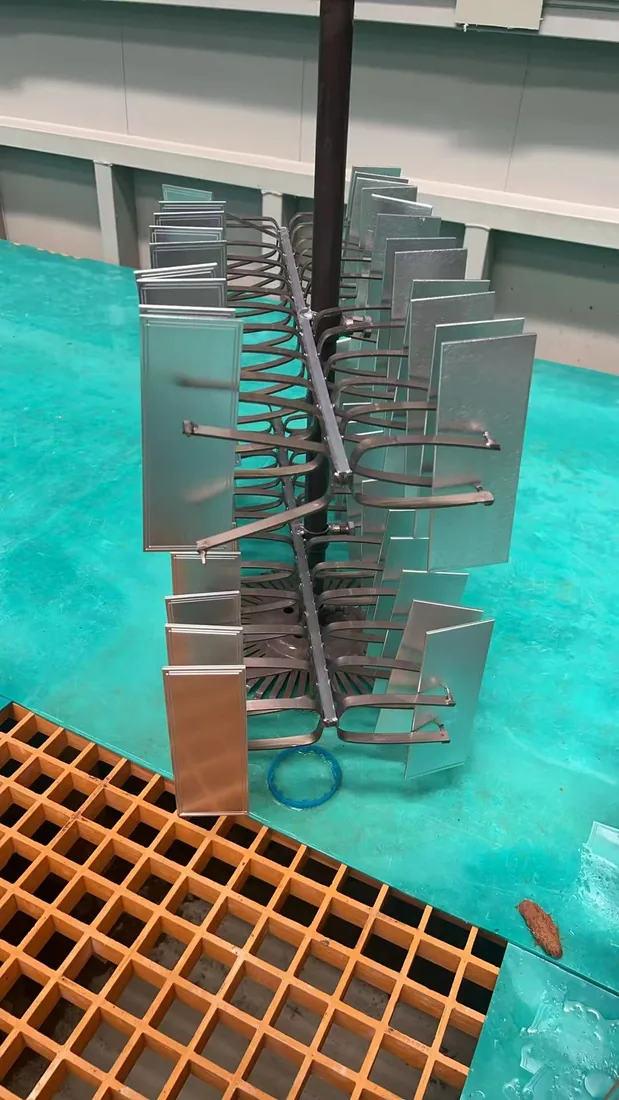 Rack of aluminum sign plates over the anodizing and electroplating tank