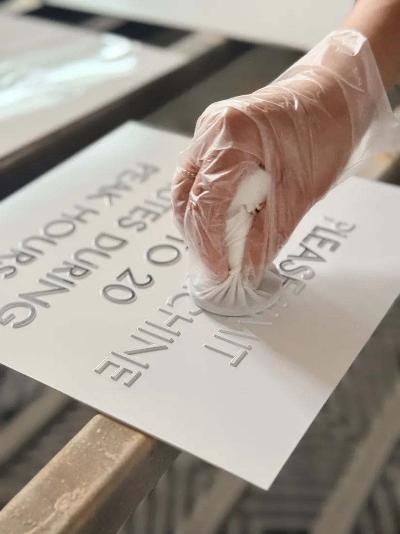 Gloved hand painting engraved acrylic sign letters