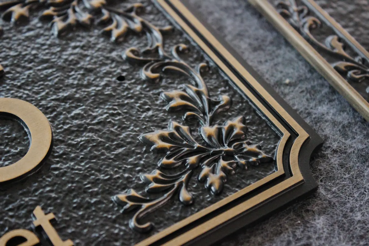 Raised border finish detail for exterior or villa plaque